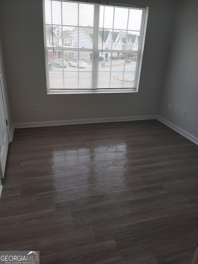 empty room featuring dark wood-type flooring