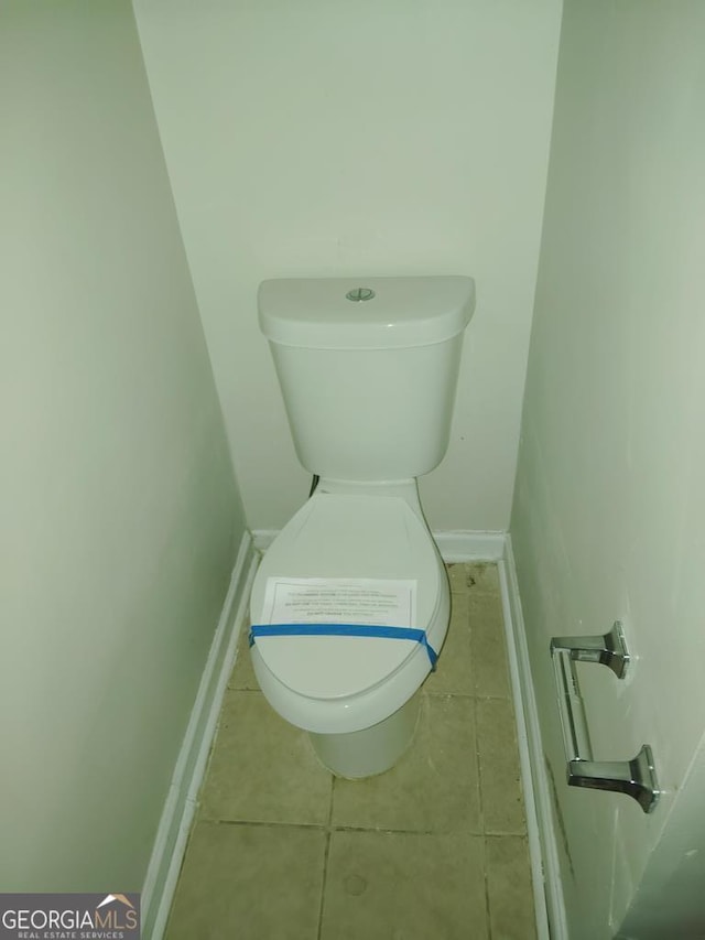 bathroom with tile patterned floors and toilet