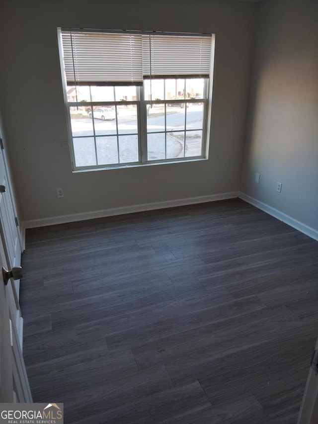 unfurnished room featuring dark hardwood / wood-style flooring