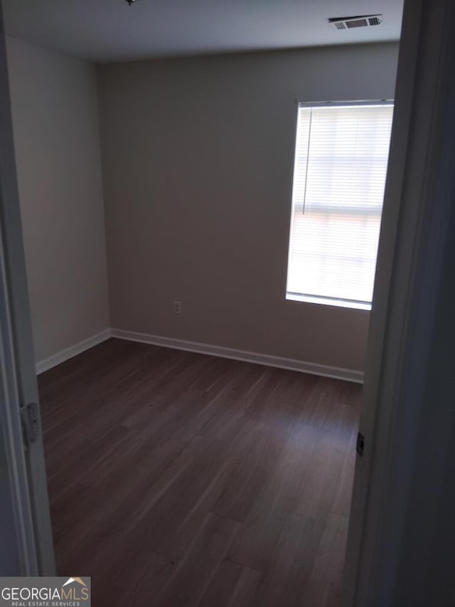 unfurnished room with dark hardwood / wood-style floors