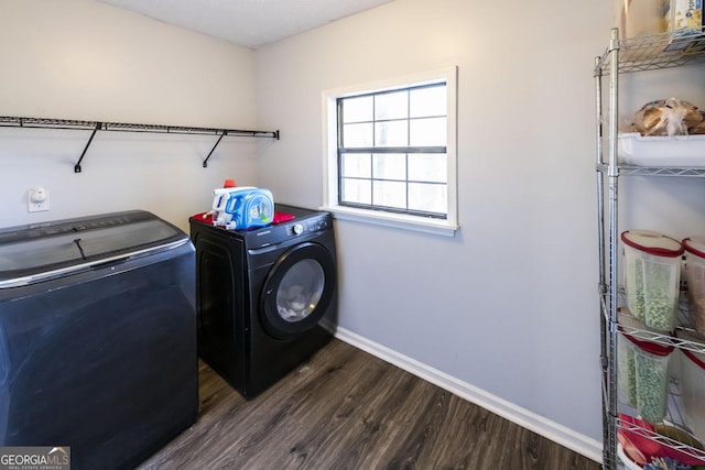 washroom featuring dark wood-type flooring and separate washer and dryer