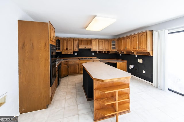 kitchen with sink, black gas cooktop, and a kitchen island