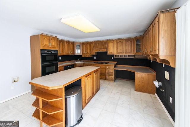 kitchen featuring sink, black appliances, and a center island