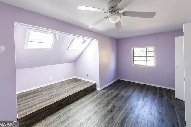 additional living space with lofted ceiling, ceiling fan, and dark wood-type flooring