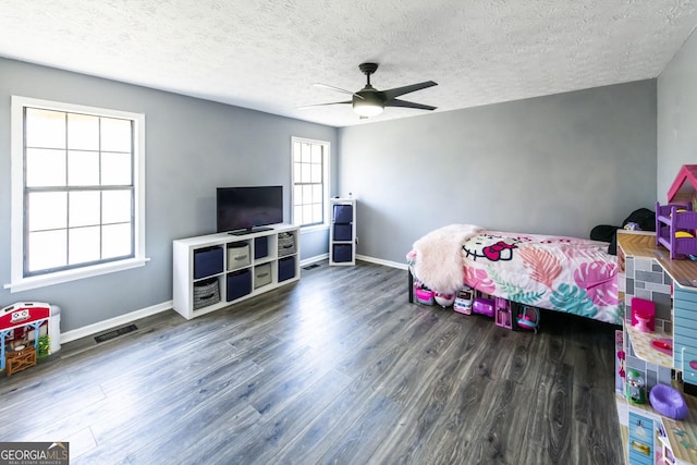 bedroom with ceiling fan, a textured ceiling, and hardwood / wood-style flooring