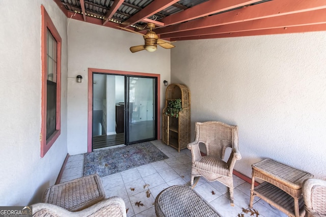 entrance to property with ceiling fan and a patio area