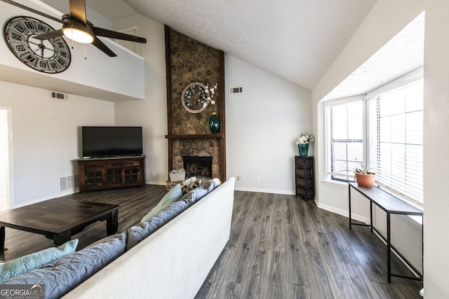 living room with a fireplace, ceiling fan, dark wood-type flooring, and high vaulted ceiling