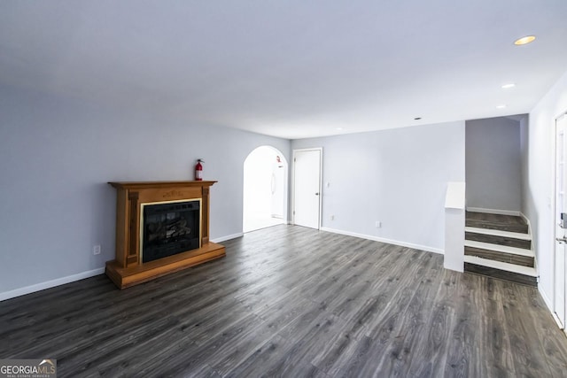 unfurnished living room featuring dark hardwood / wood-style flooring