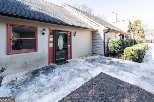 entrance to property featuring a patio area