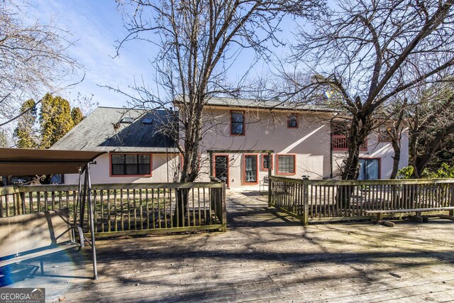 rear view of property with a wooden deck