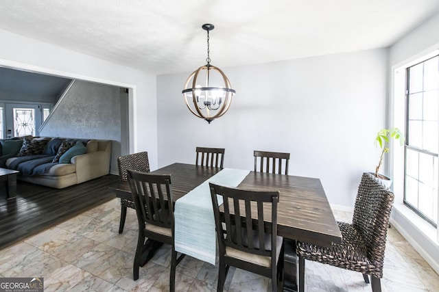 dining area with a healthy amount of sunlight, french doors, and a notable chandelier