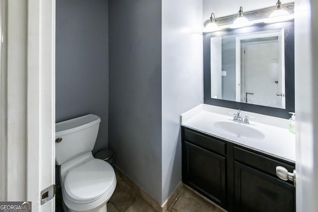 bathroom featuring toilet and vanity