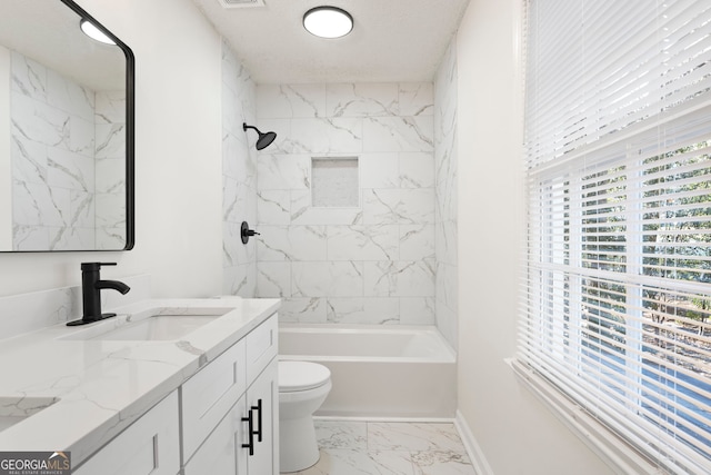 full bathroom featuring toilet, vanity, and tiled shower / bath