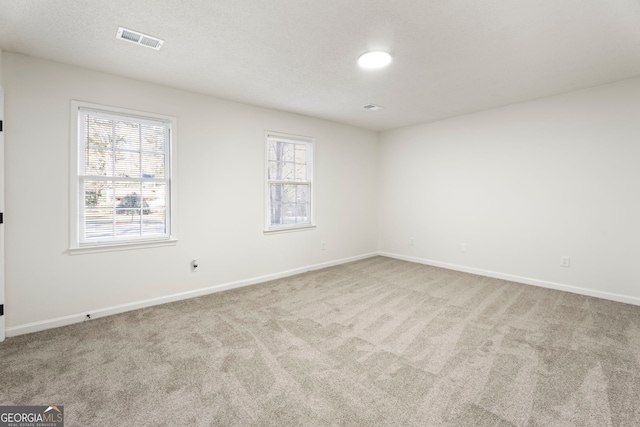 empty room with light colored carpet