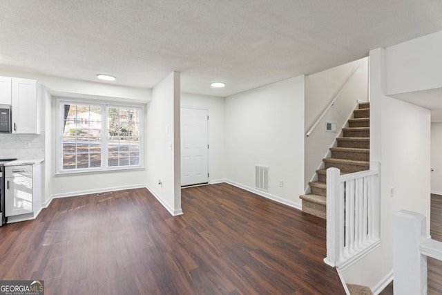 interior space with dark hardwood / wood-style flooring and a textured ceiling