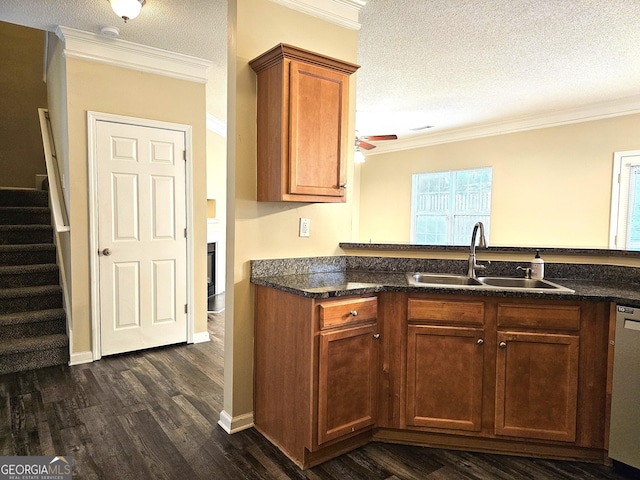 kitchen featuring dishwasher, sink, a textured ceiling, and ornamental molding