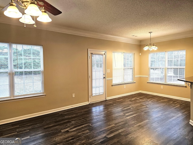 unfurnished room with dark wood-type flooring, a wealth of natural light, and a notable chandelier