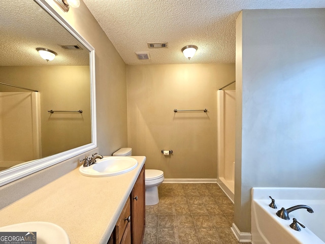 full bathroom featuring vanity, separate shower and tub, toilet, and a textured ceiling