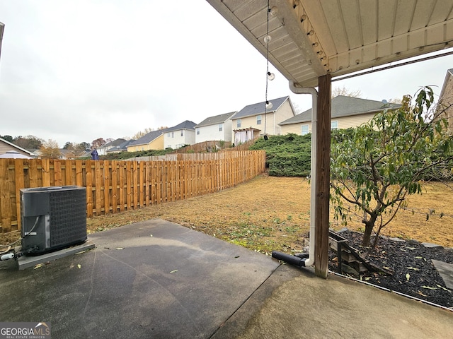 view of yard with central AC and a patio area