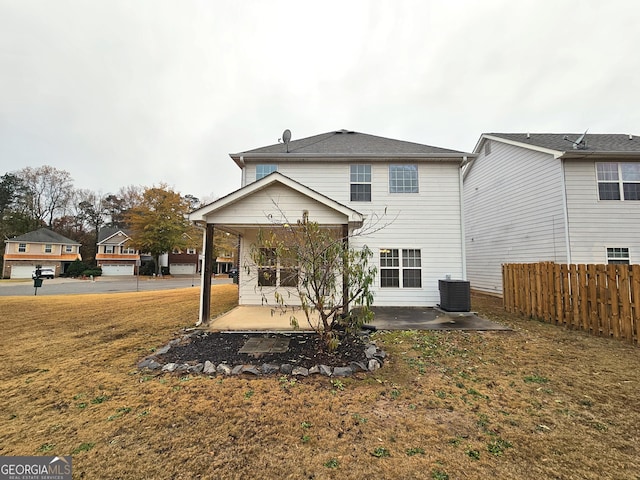 back of property featuring a patio area, a yard, and cooling unit