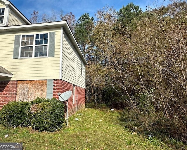 view of side of property with a lawn