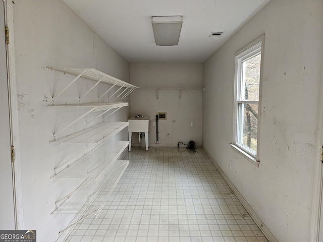 clothes washing area with sink