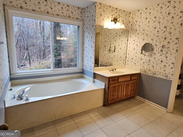 bathroom featuring a bathing tub, tile patterned flooring, and vanity