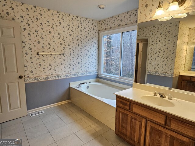 bathroom featuring a washtub, vanity, and tile patterned floors