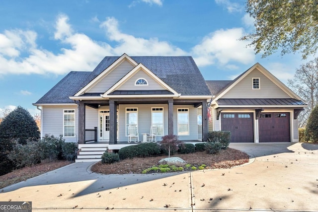 view of front facade featuring covered porch and a garage