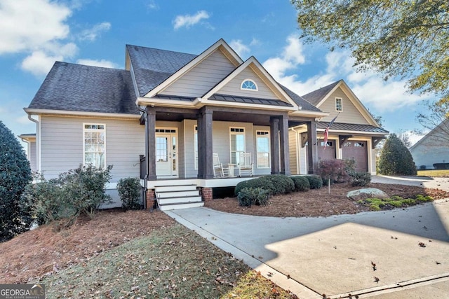 craftsman inspired home featuring a porch and a garage