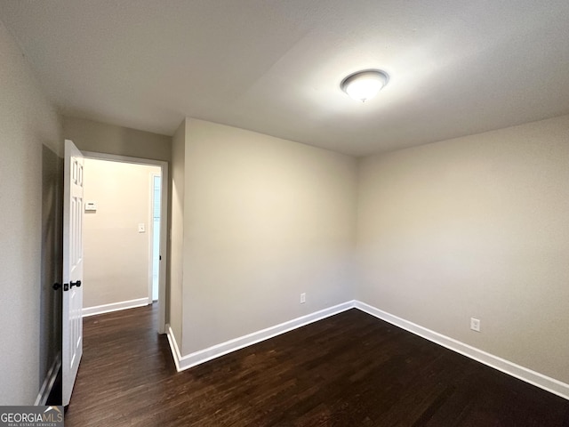 empty room with dark wood-type flooring