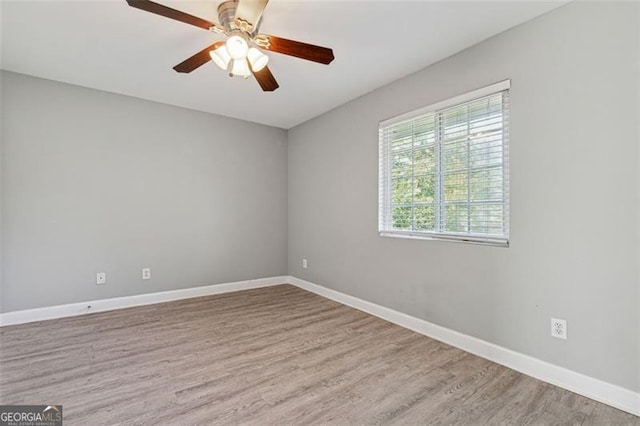 empty room with hardwood / wood-style floors and ceiling fan