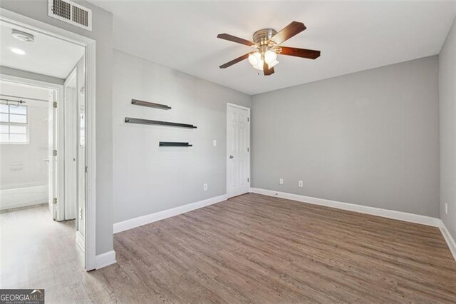 empty room featuring ceiling fan and hardwood / wood-style flooring