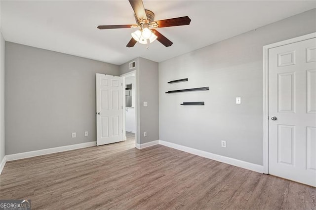 unfurnished bedroom with ceiling fan and wood-type flooring