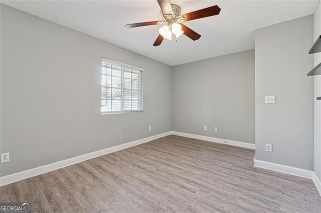 empty room featuring ceiling fan and light hardwood / wood-style flooring