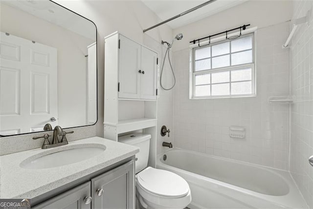 full bathroom with vanity, toilet, and tiled shower / bath combo