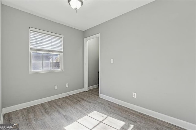 empty room with light hardwood / wood-style flooring