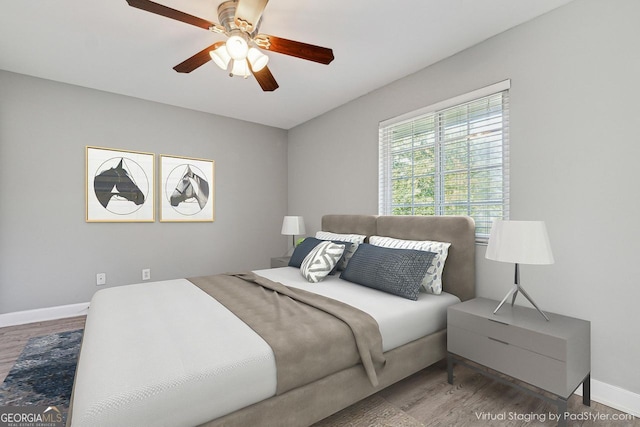 bedroom with hardwood / wood-style flooring and ceiling fan