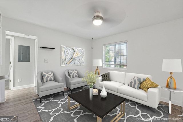 living room featuring electric panel, ceiling fan, and dark wood-type flooring