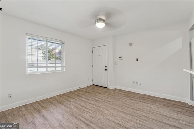 spare room with light hardwood / wood-style flooring and ceiling fan