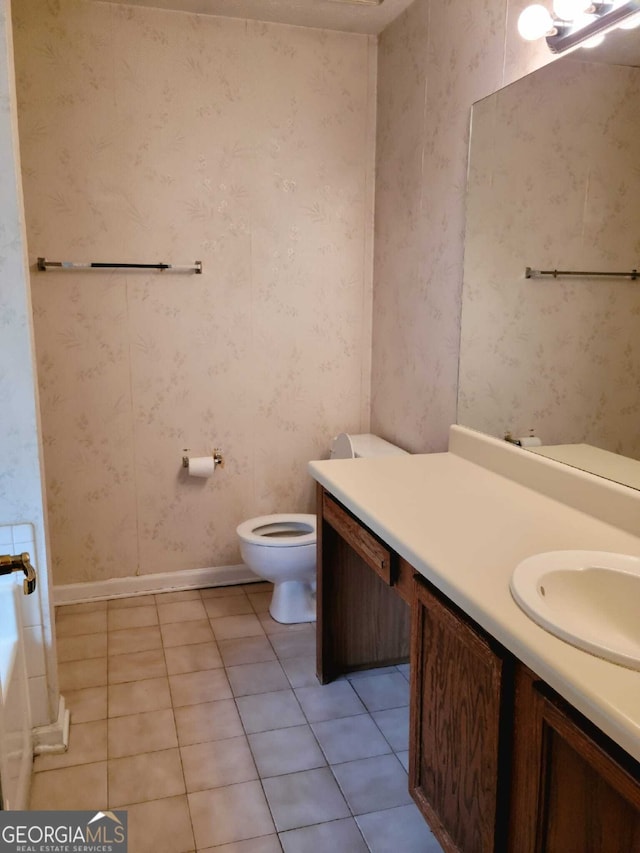 bathroom featuring tile patterned flooring, vanity, and toilet