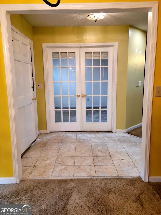 doorway to outside with french doors and light colored carpet