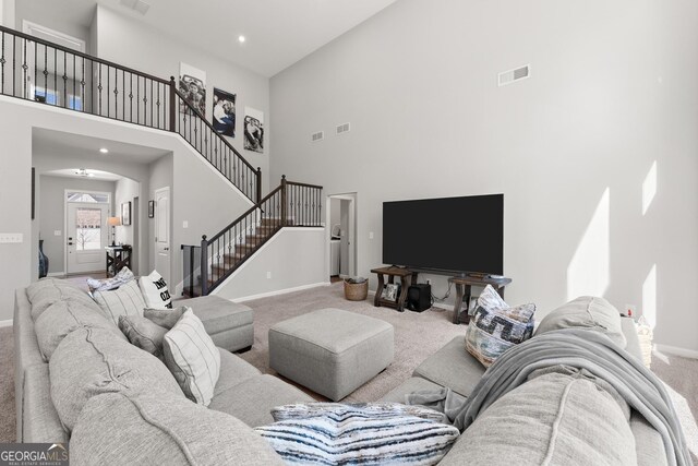 bedroom with carpet floors and a raised ceiling