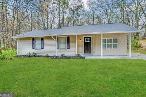 ranch-style house with a porch and a front yard