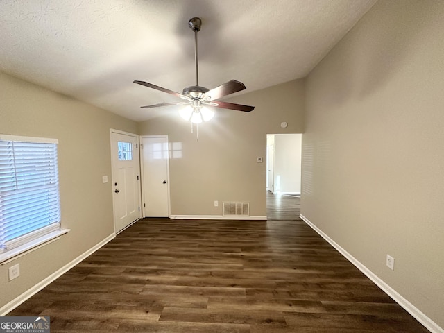 foyer with a textured ceiling, lofted ceiling, ceiling fan, and dark hardwood / wood-style floors