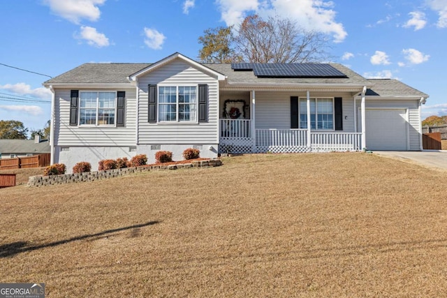 ranch-style home with a front yard, a porch, solar panels, and a garage