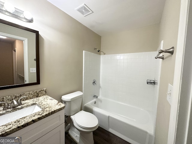 full bathroom with hardwood / wood-style floors, vanity, toilet, and shower / bathing tub combination