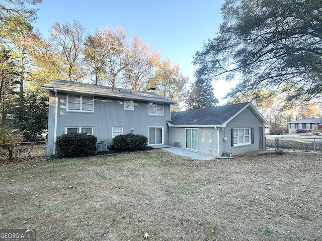 back of house with a lawn