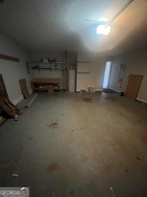 basement featuring gas water heater and a textured ceiling