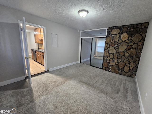 carpeted spare room with a textured ceiling